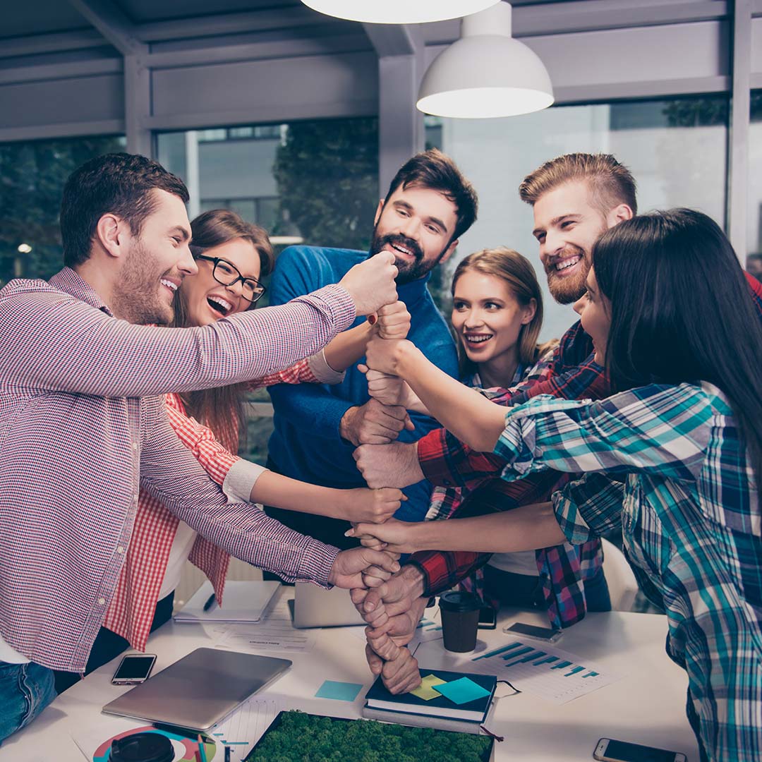 Happy,Businesspeople,Putting,Their,Fist,On,Top,Of,Each,Other